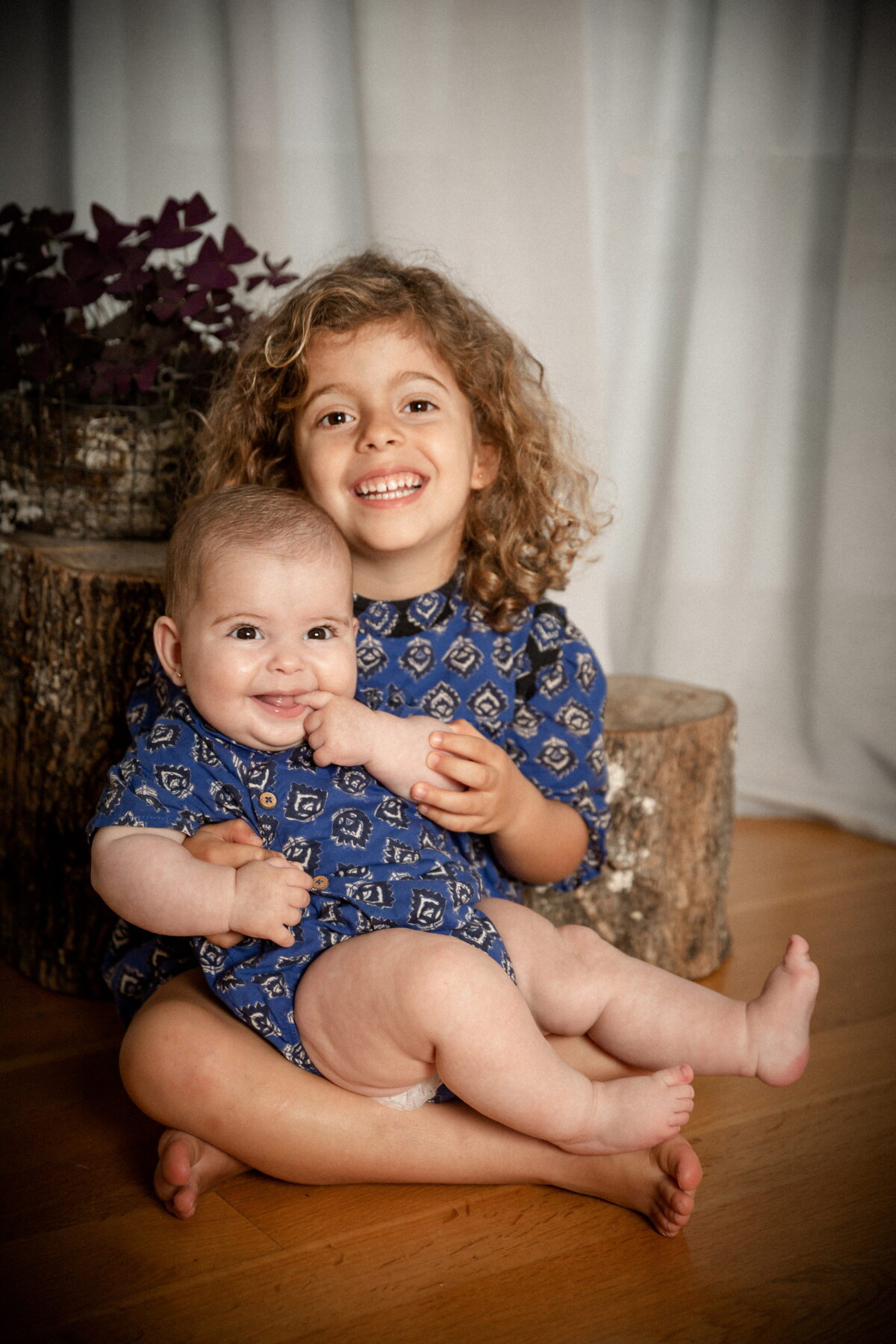 Dos hermanas abrazadas sentadas en el suelo